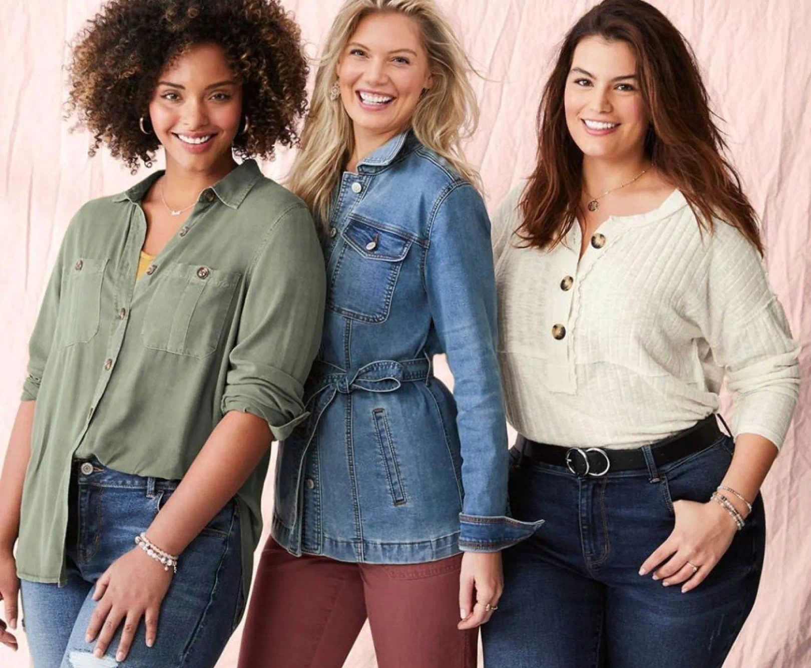 three people standing together smiling