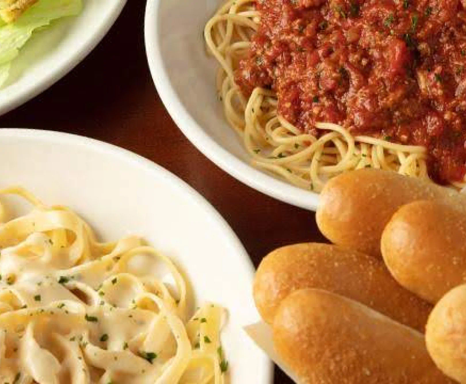pasta and breadsticks on table
